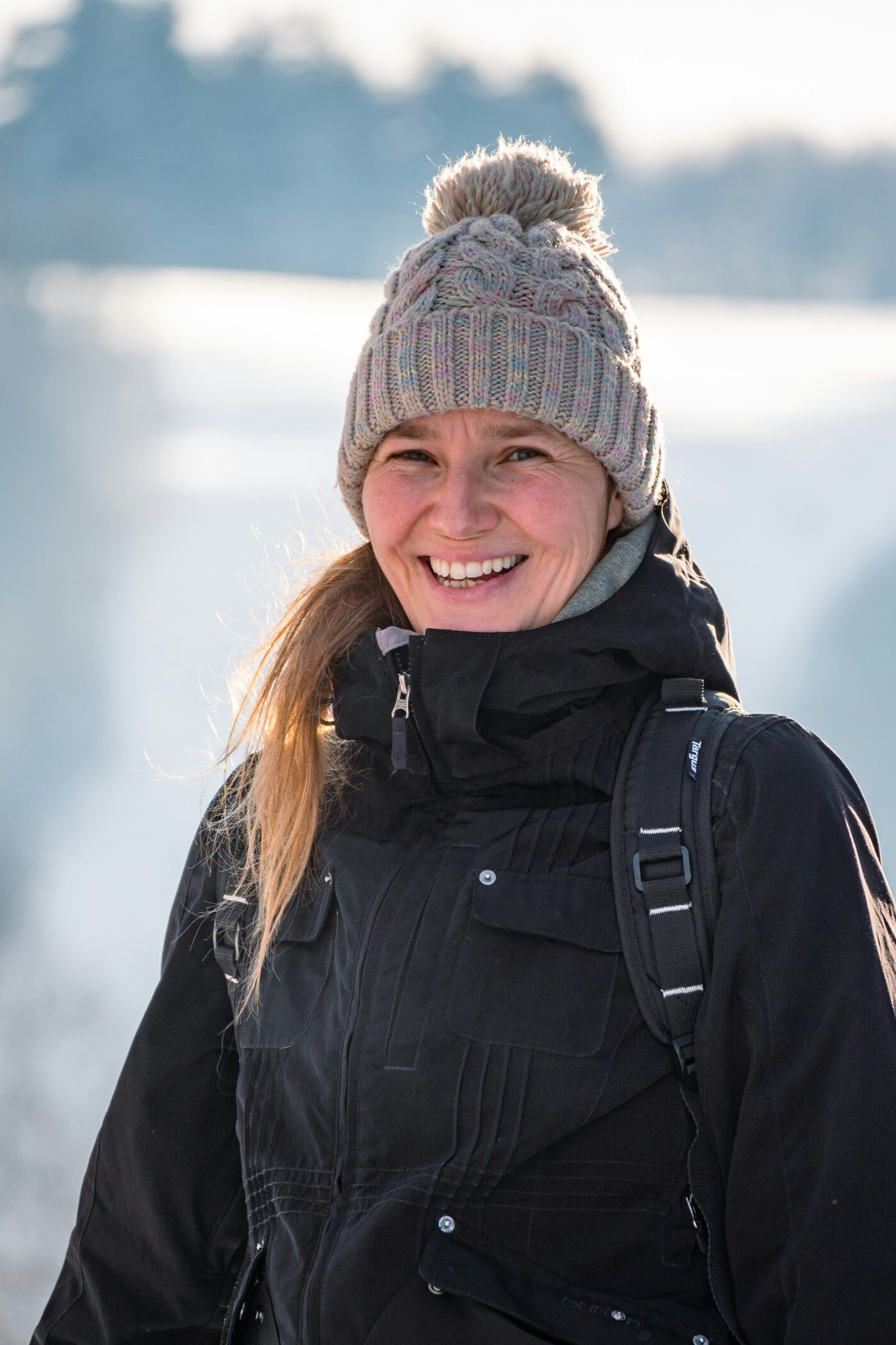 Woman dressed for winter in a thick coat and wooly hat